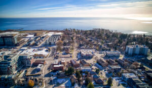 Aerial view of residential neighbourhood near 320 and 322 Lakeshore Road West with Lake Ontario in the background