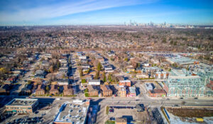 Aerial view inland from 320 and 322 Lakeshore Road West showing surrounding neighbourhood and distant skyline