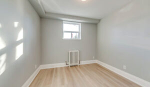 Bedroom interior with natural light and neutral finishes at 320 and 322 Lakeshore Road West