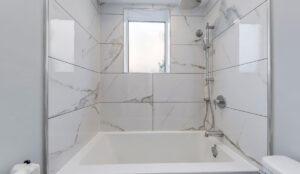 Bathroom tub and shower with tiled walls at 320 and 322 Lakeshore Road West