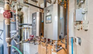 Mechanical room with dual boiler systems, exposed piping, and utility equipment