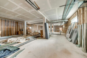 Spacious medical office interior under construction with exposed ductwork and framing