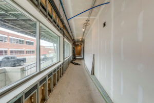 Interior corridor of medical office building under construction with large windows and natural light