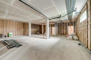 Large unfinished medical office space with framed rooms and mechanical systems in progress