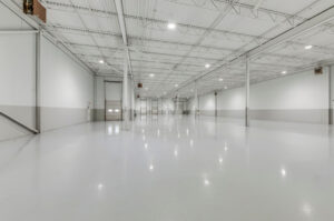 Warehouse interior with drive-in door and epoxy floor at 7205 Edwards Boulevard