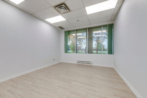Interior office space with large windows at 7205 Edwards Boulevard